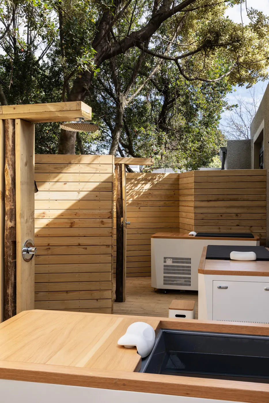 Outdoor shower on a timber deck at The Well wellness retreat