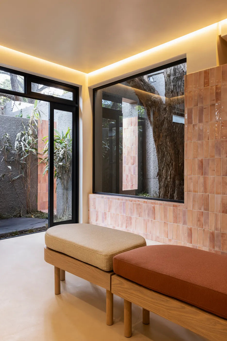 Treatment room with a daybed and garden outlook at The Well