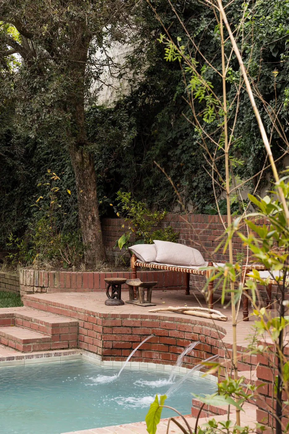 The Well's outdoor plunge pool surrounded by an indigenous garden